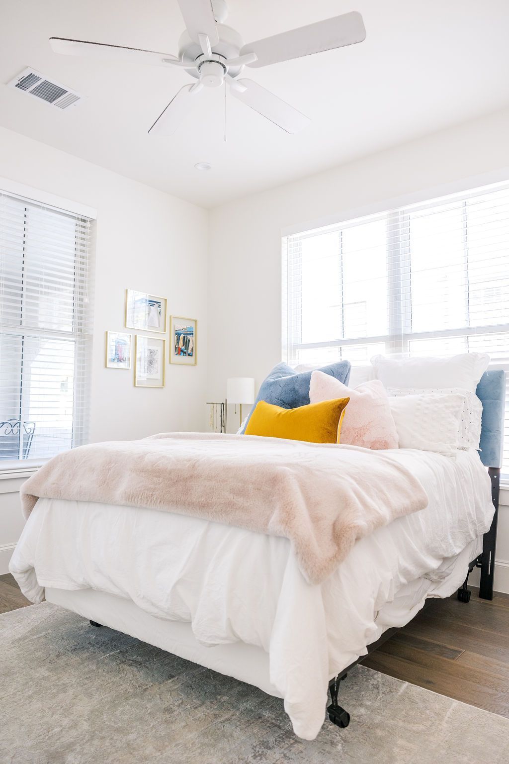 A bedroom with a bed and a ceiling fan.