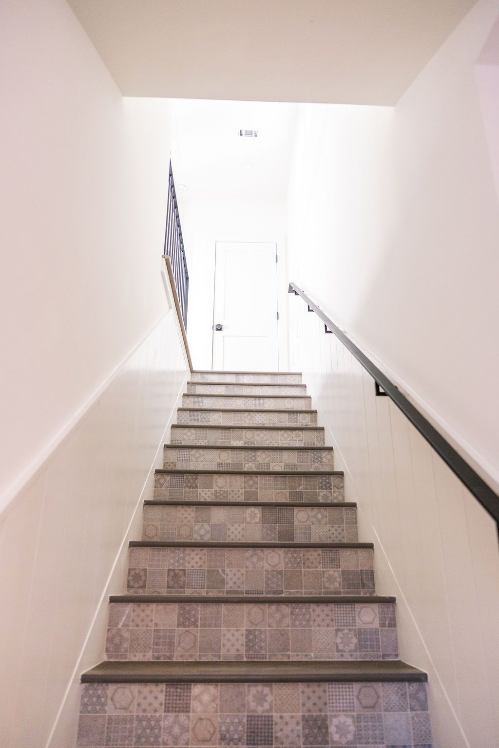 A set of stairs leading up to a white wall.