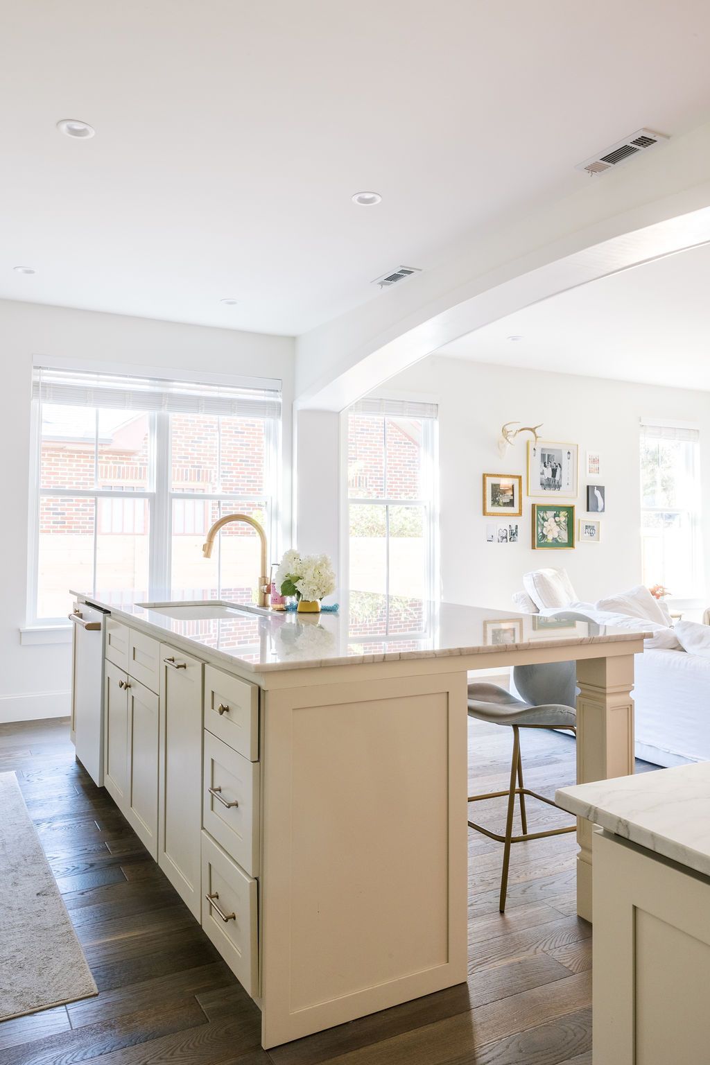 A kitchen with a large island in the middle and a sink.