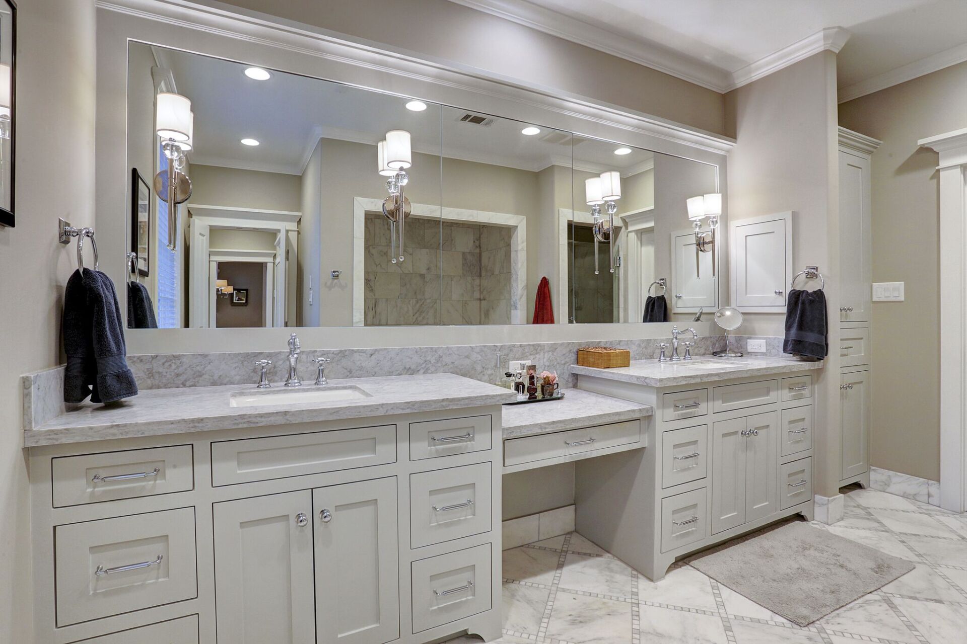 A bathroom with two sinks and a large mirror.