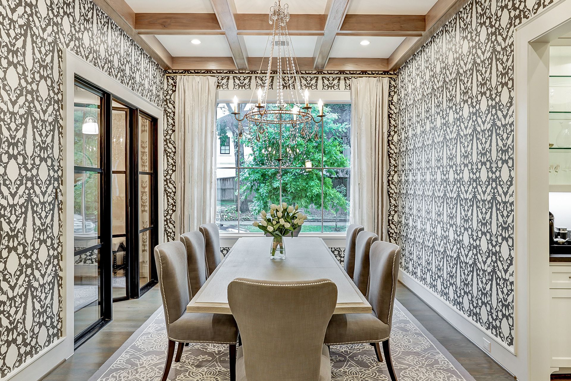 A dining room with a table and chairs and a chandelier