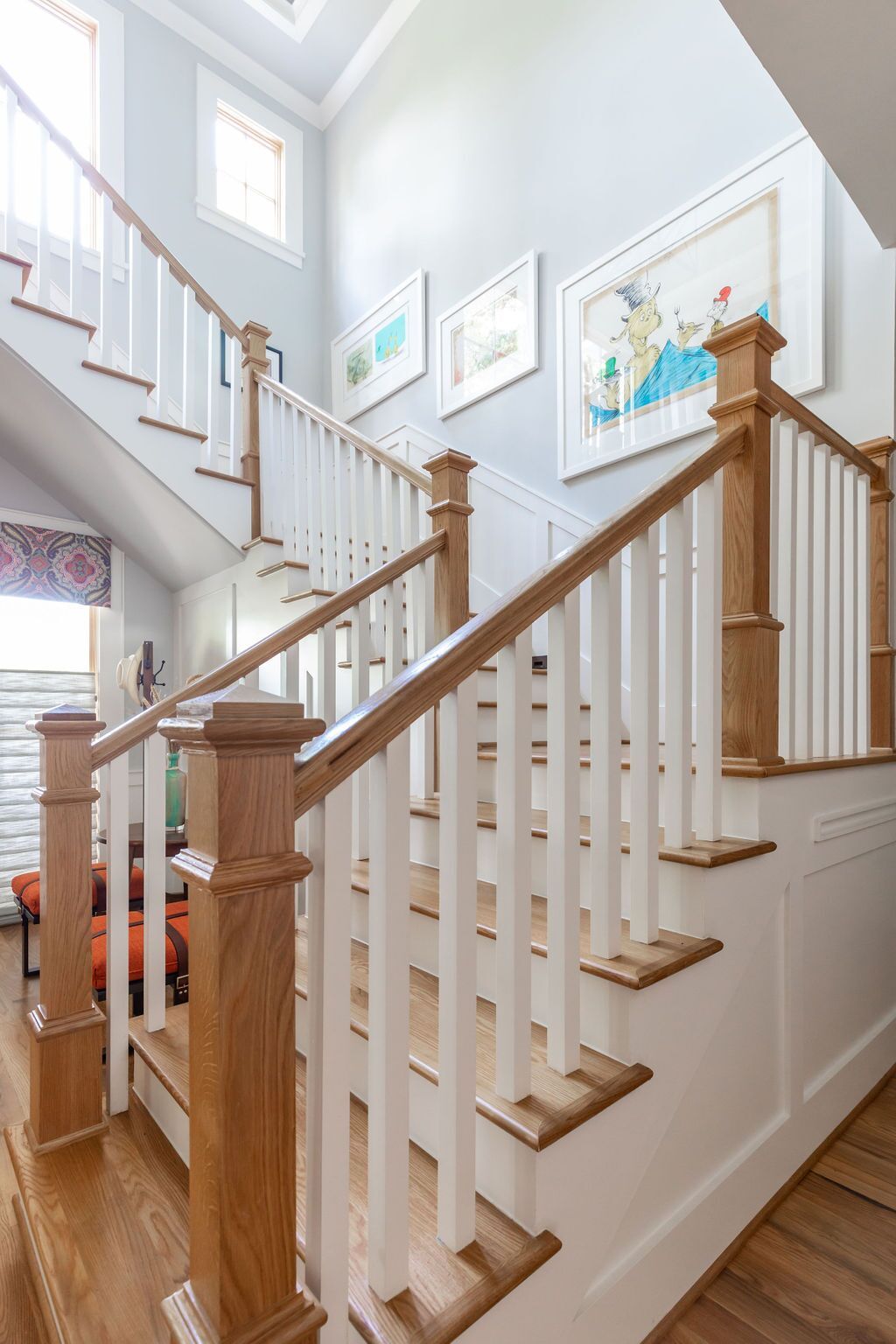 A staircase with white railings and wooden handrails in a house.