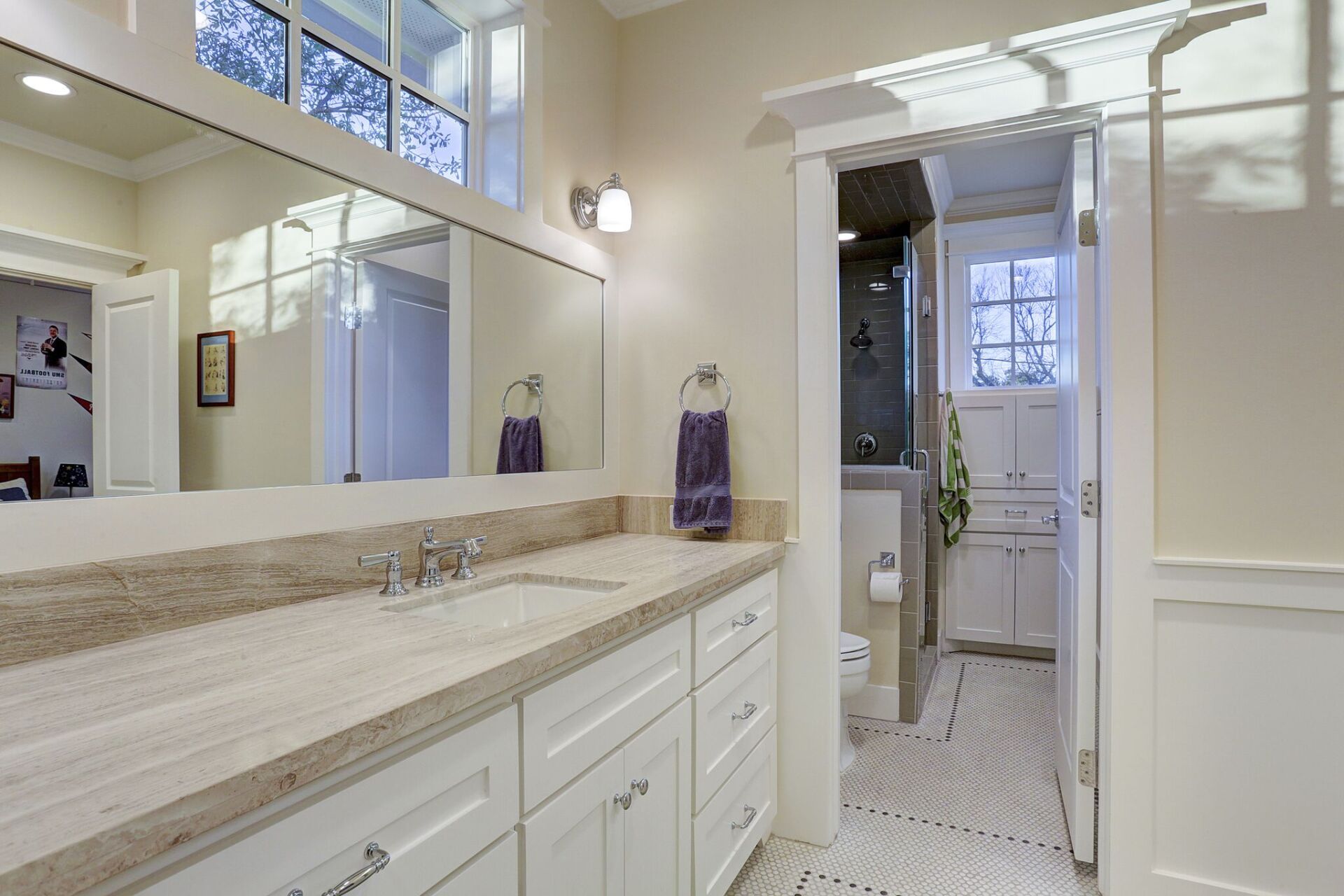 A bathroom with two sinks and a large mirror.