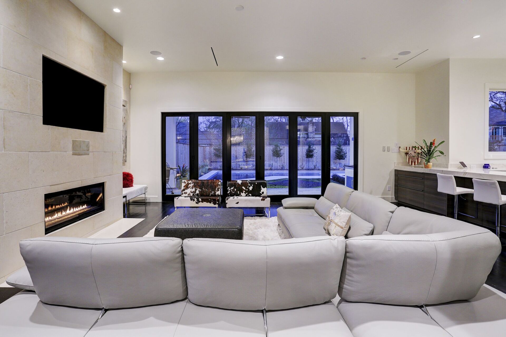 A living room with a couch , fireplace and television.