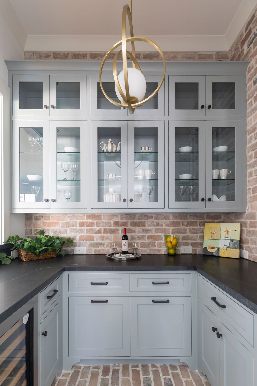 A kitchen with a bottle of wine on the counter.