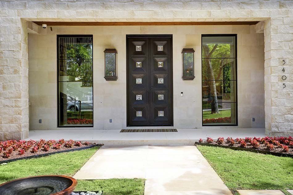 The front of a house with a black door and windows