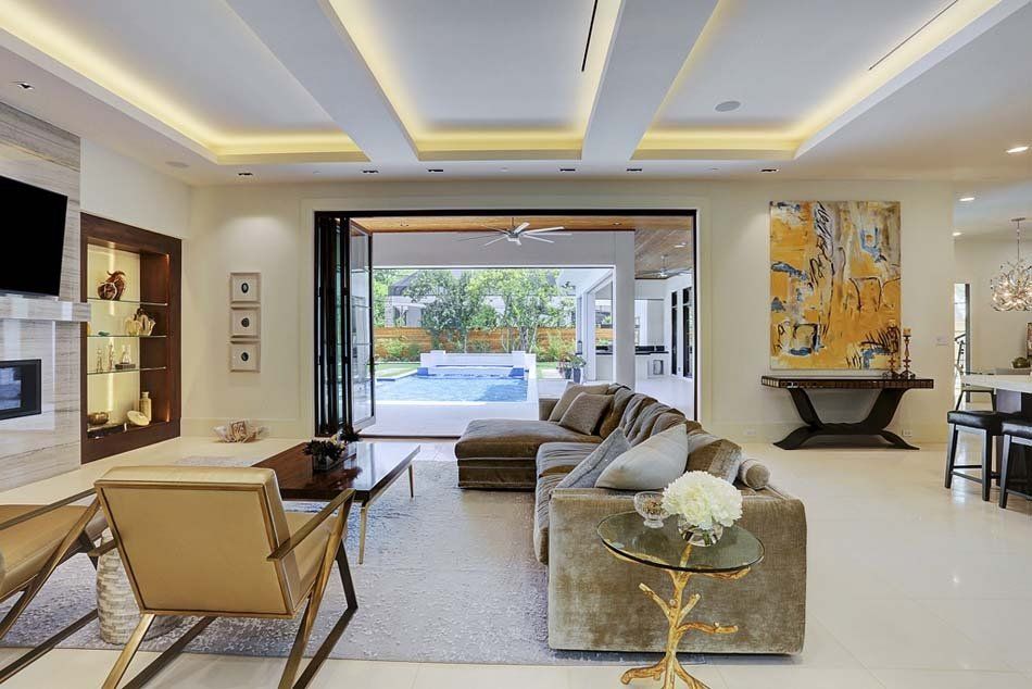 A living room with a couch , chairs and a table