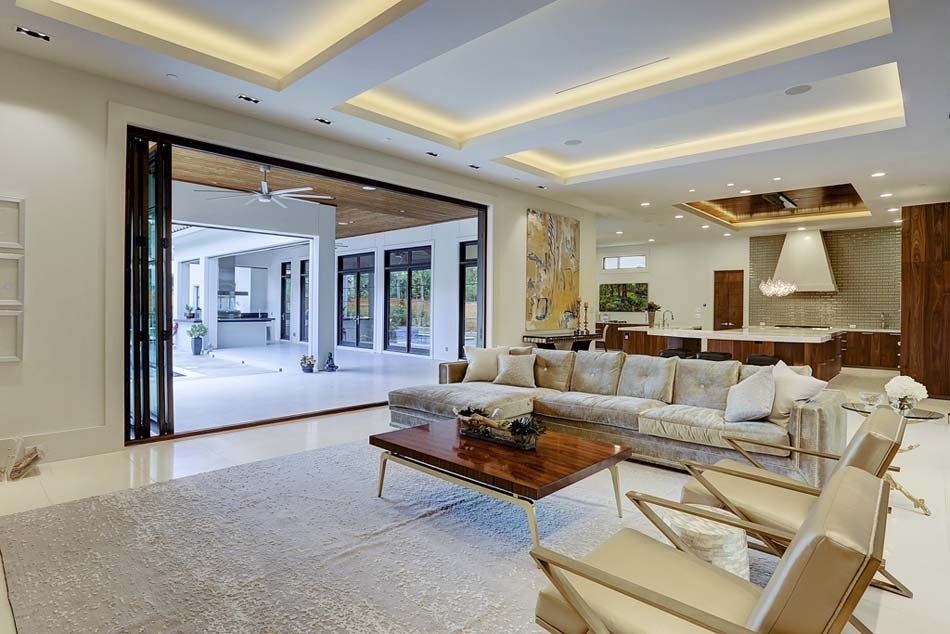 A living room with a couch , chairs and a coffee table.
