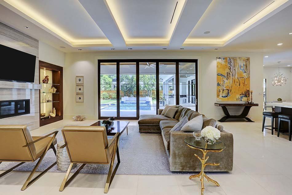 A living room with a couch , chairs , and a fireplace.