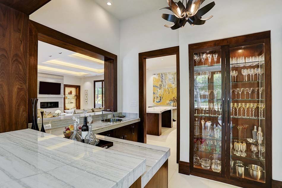A kitchen with a bar and a wine cellar