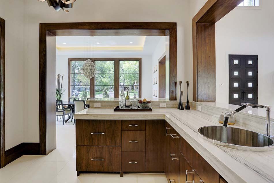 A kitchen with wooden cabinets and a stainless steel sink