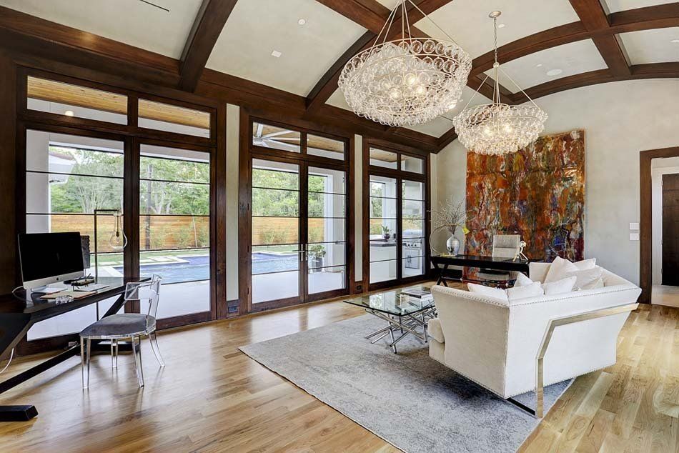 A living room with a white couch and a desk