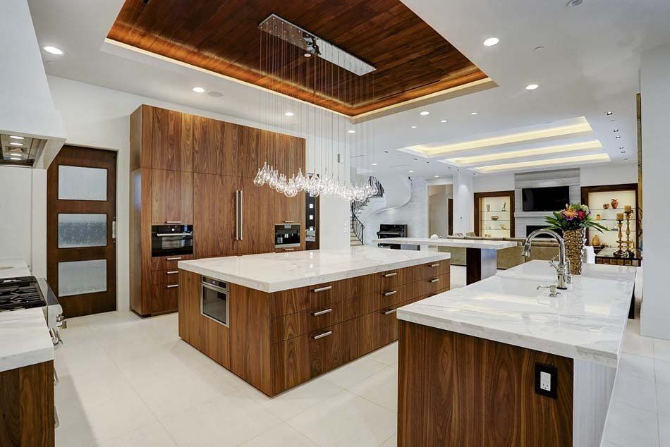 A large kitchen with wooden cabinets and white counter tops.