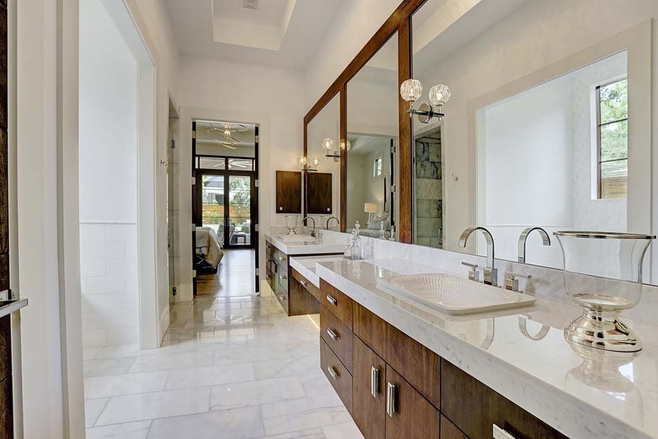 A bathroom with two sinks and two mirrors.