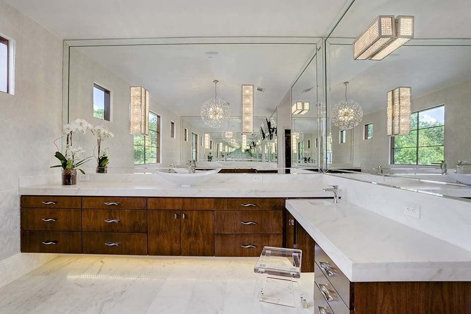 A bathroom with two sinks and a large mirror.
