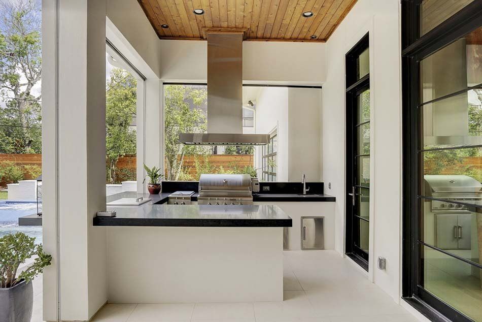 A kitchen with a grill and a large window