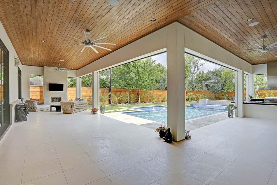 A large room with a ceiling fan and a swimming pool