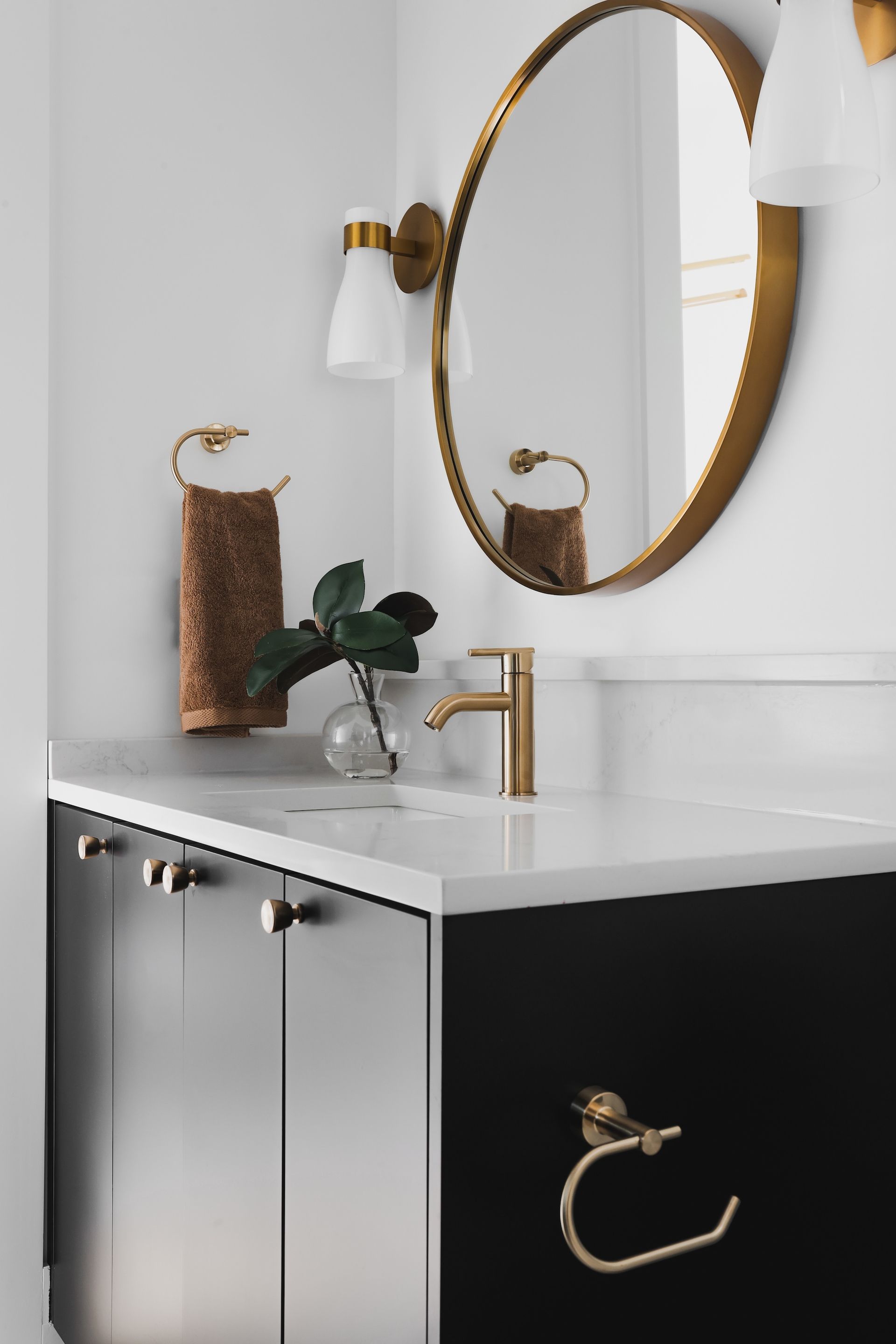 A bathroom with a sink , mirror and towel rack