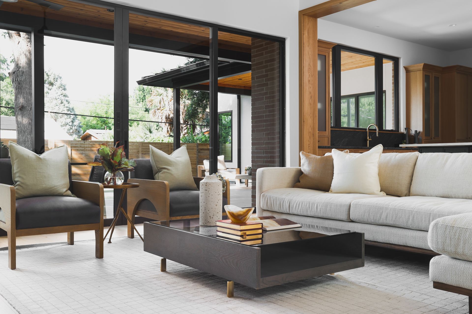 A living room with a couch , chairs , and a coffee table.