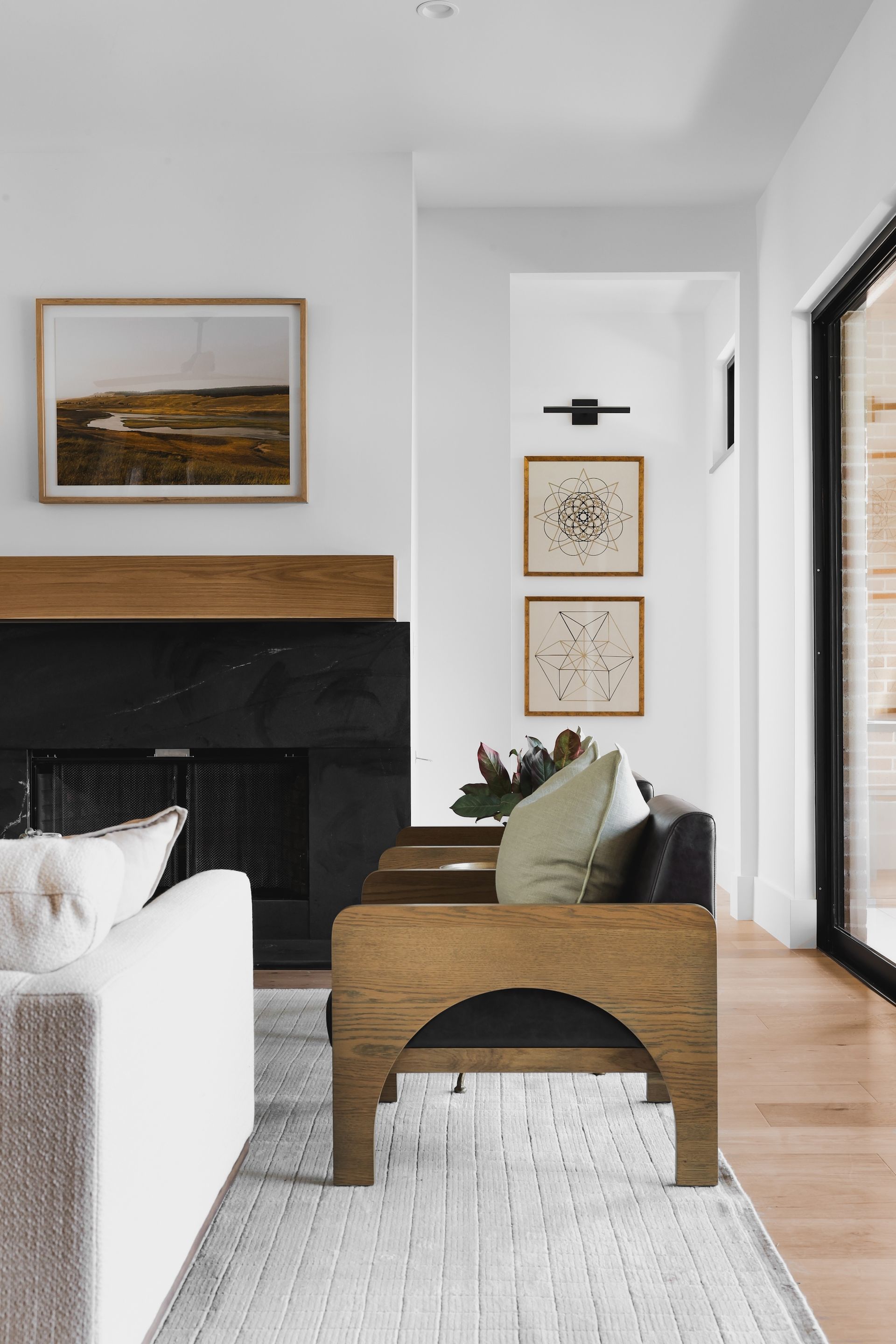 A living room with a fireplace , couch , chair and rug.