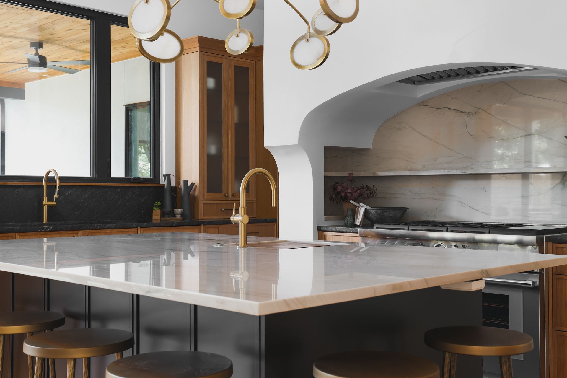 A kitchen with a large island and stools