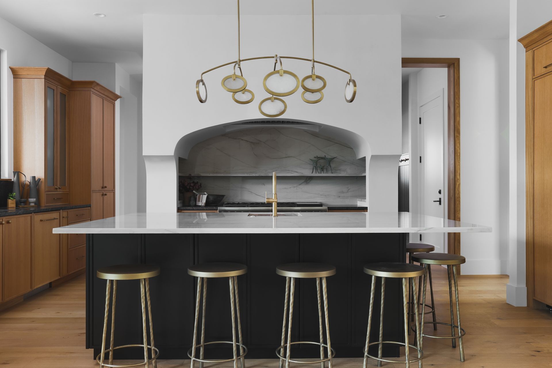 A kitchen with a large island and stools