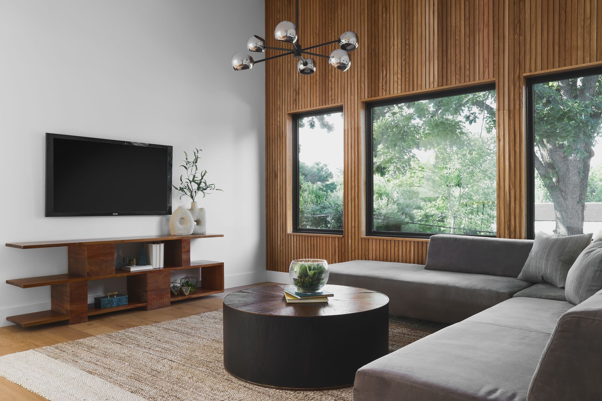 A living room with a couch , coffee table , and television.