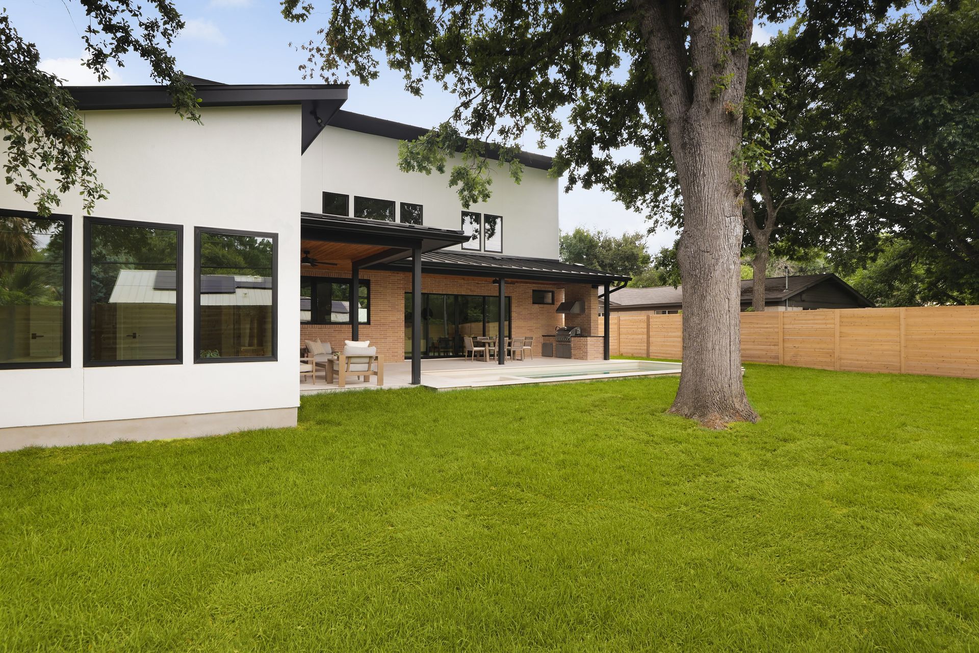A white house with a large lawn in front of it