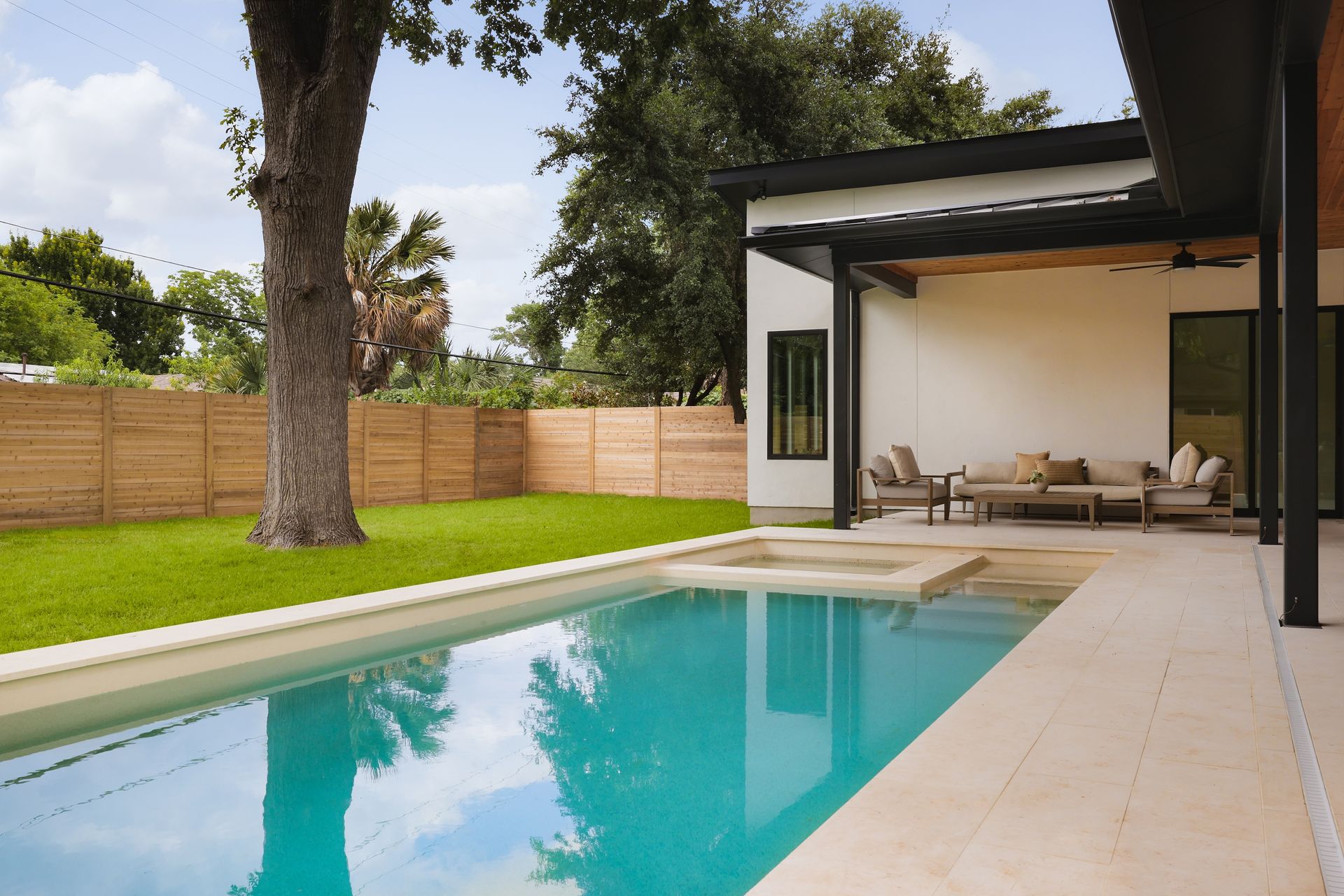 A large swimming pool in the backyard of a house
