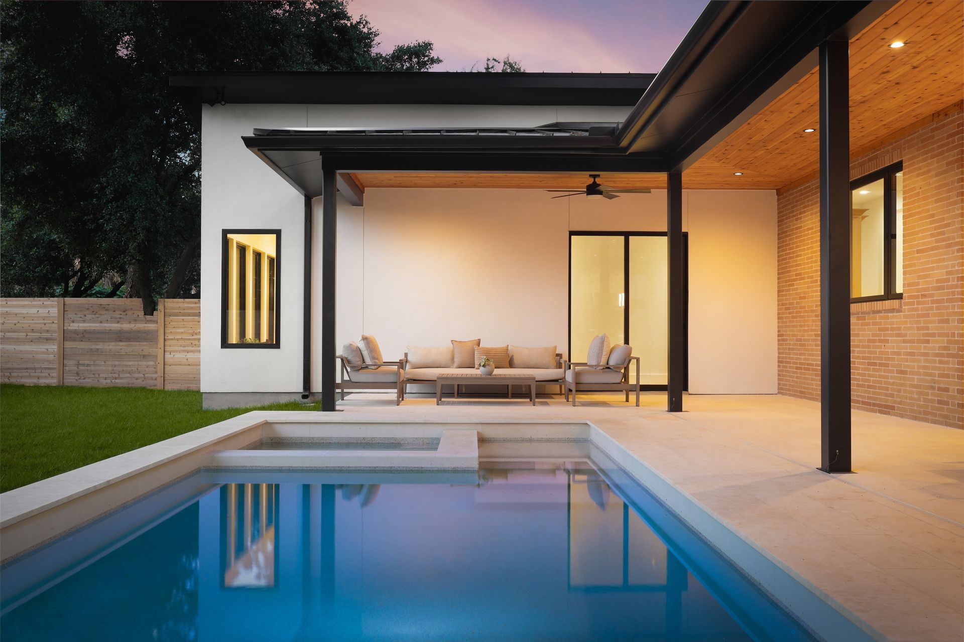 A house with a swimming pool in front of it