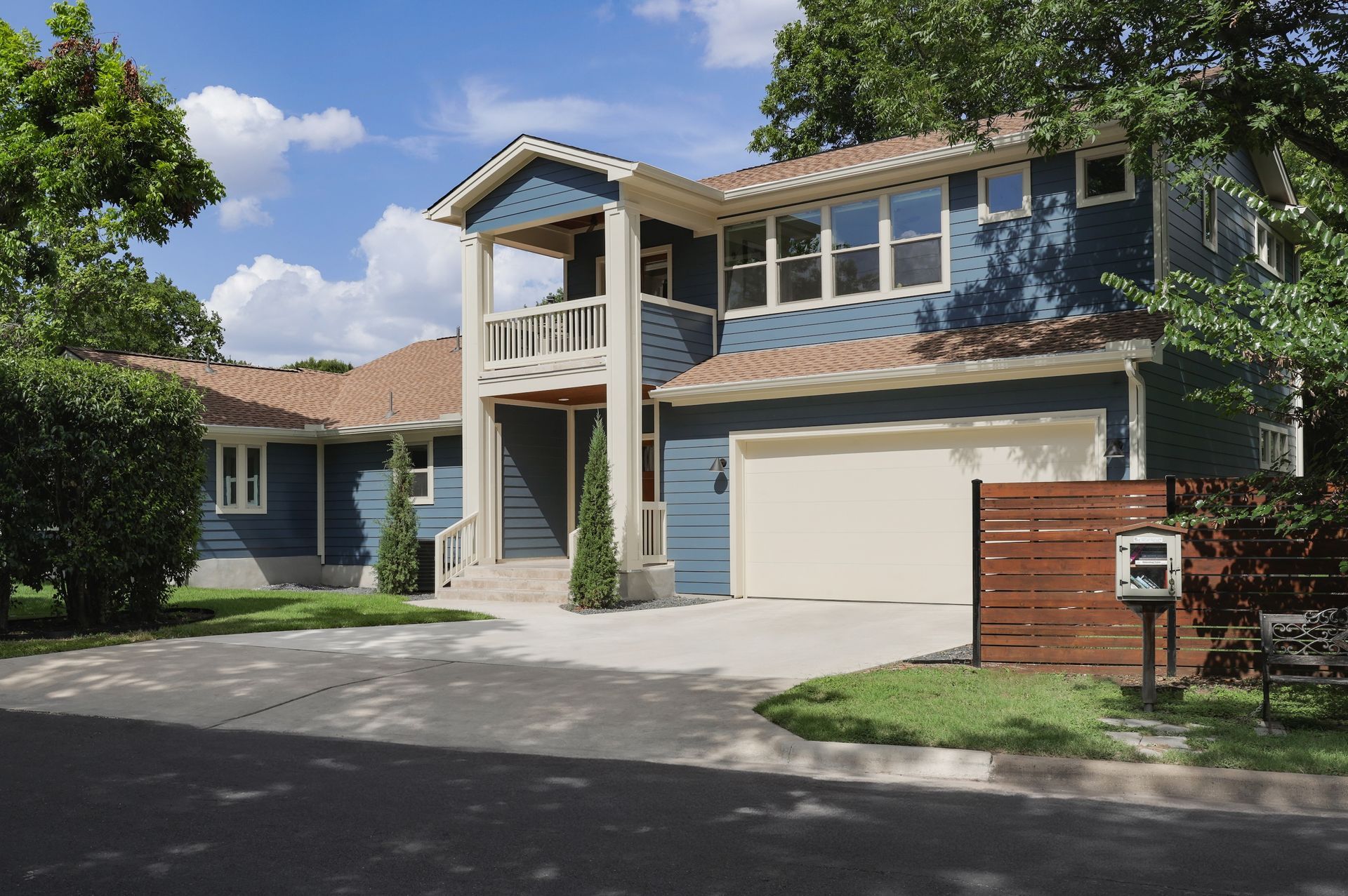 A large blue house with a white garage door