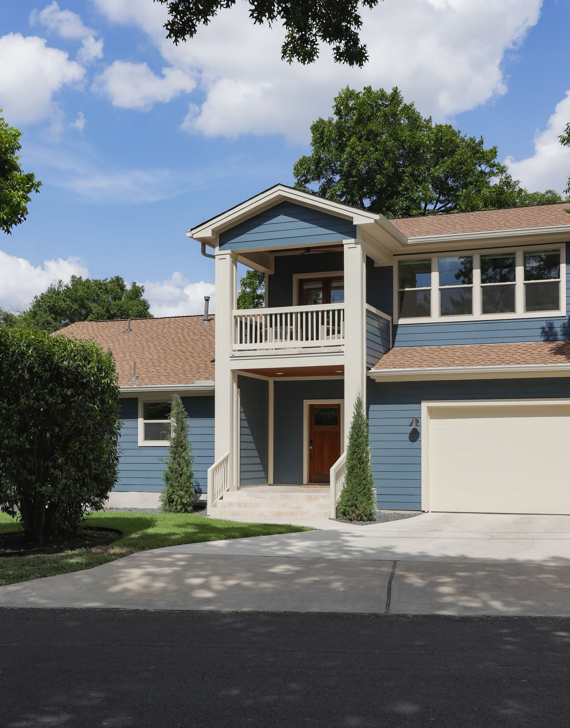 A blue and white house with a white garage door