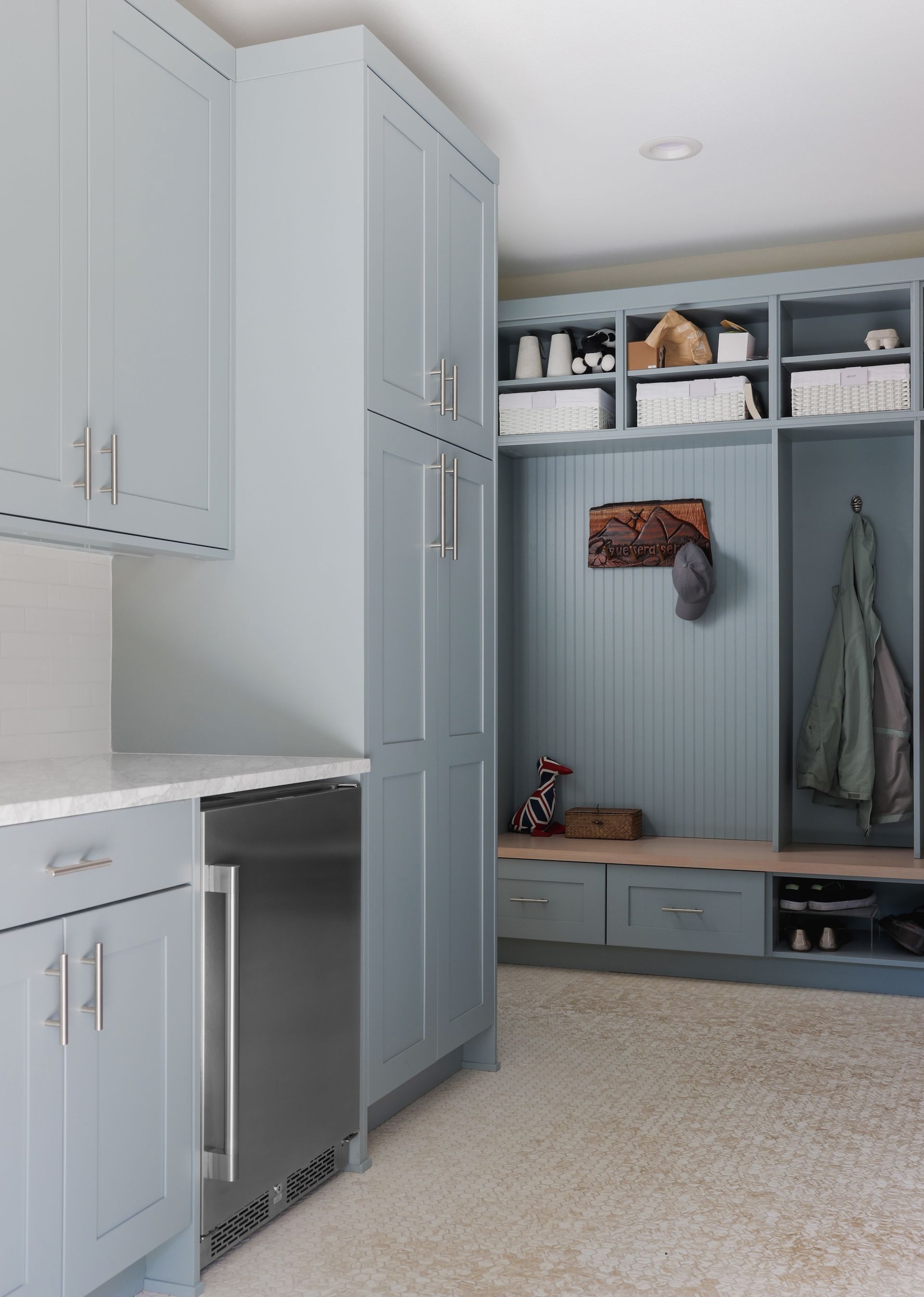 A kitchen with blue cabinets and a stainless steel dishwasher