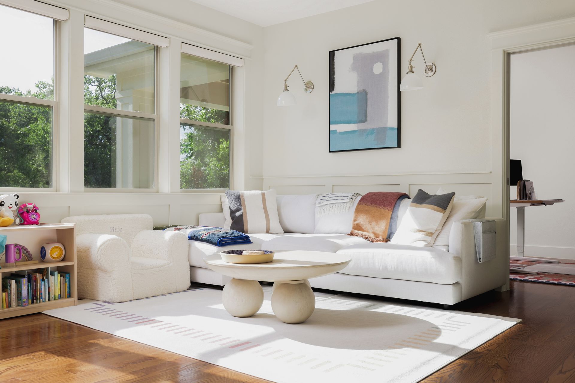A living room with a white couch and a coffee table.