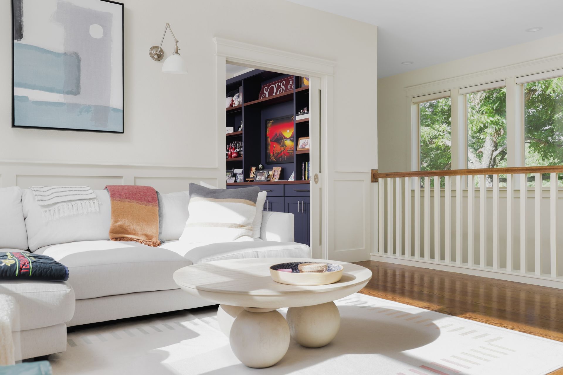 A living room with a white couch and a coffee table.