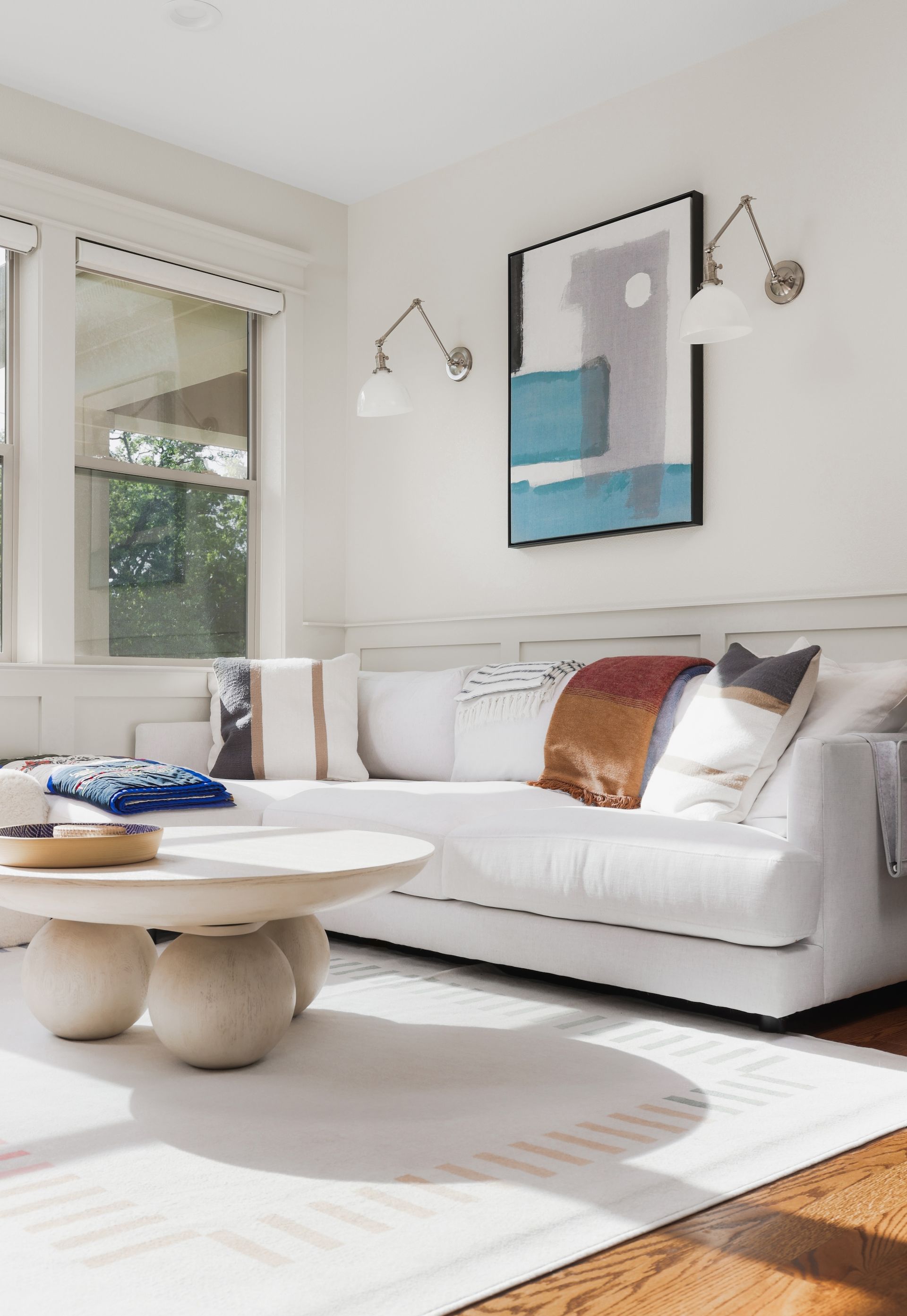 A living room with a white couch and a coffee table
