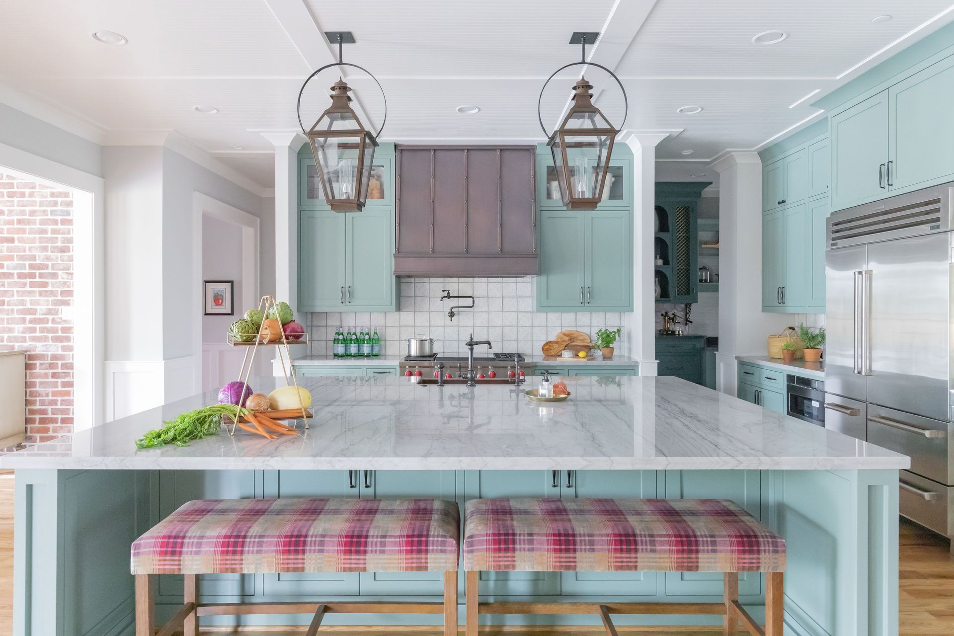 A kitchen with a large island and two benches.