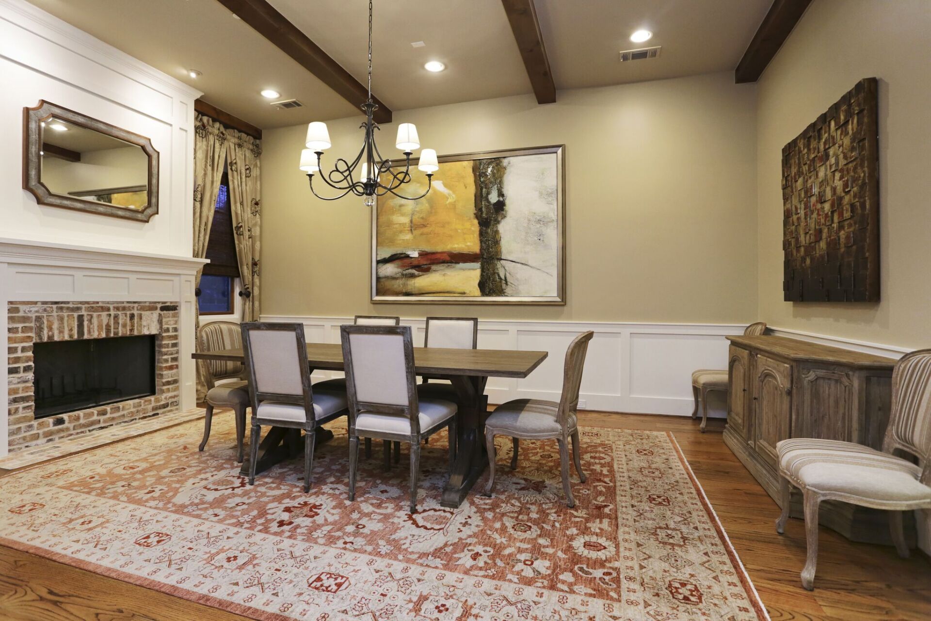 A dining room with a table and chairs and a fireplace