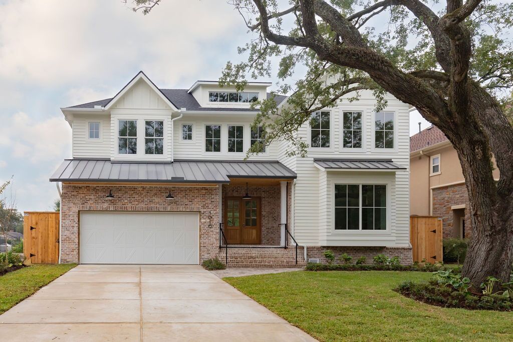 A large white house with a tree in front of it