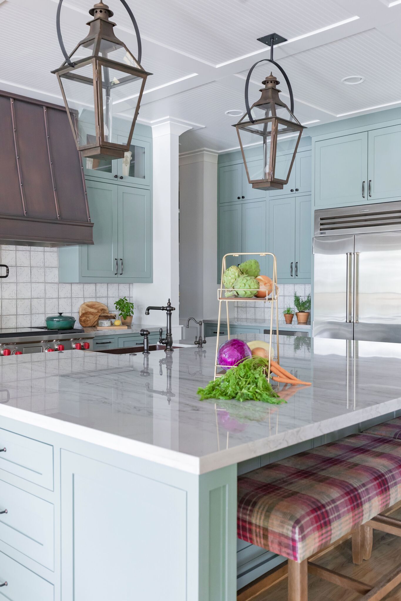 A kitchen with a large island and a bench.
