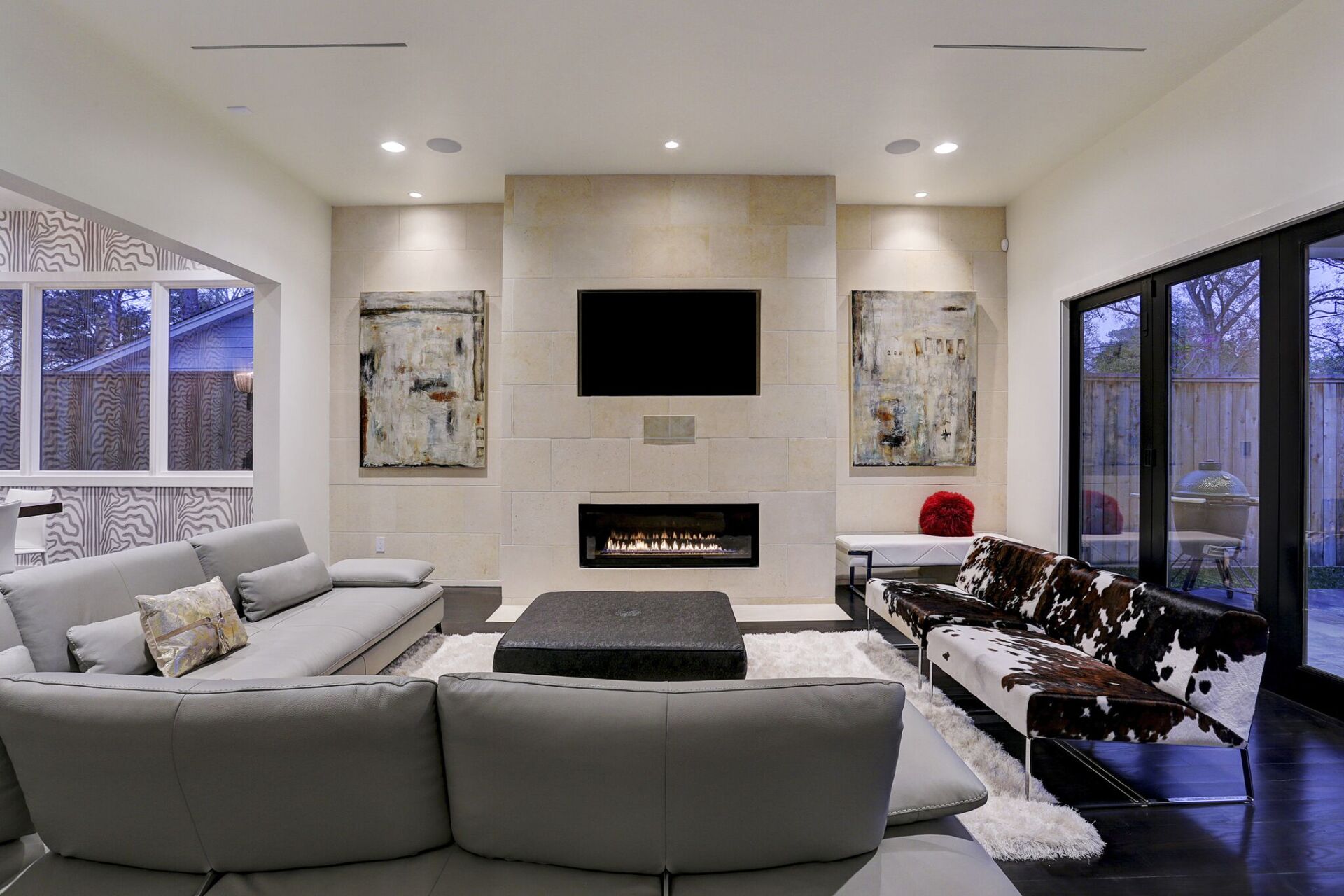 A living room with a fireplace and a flat screen tv