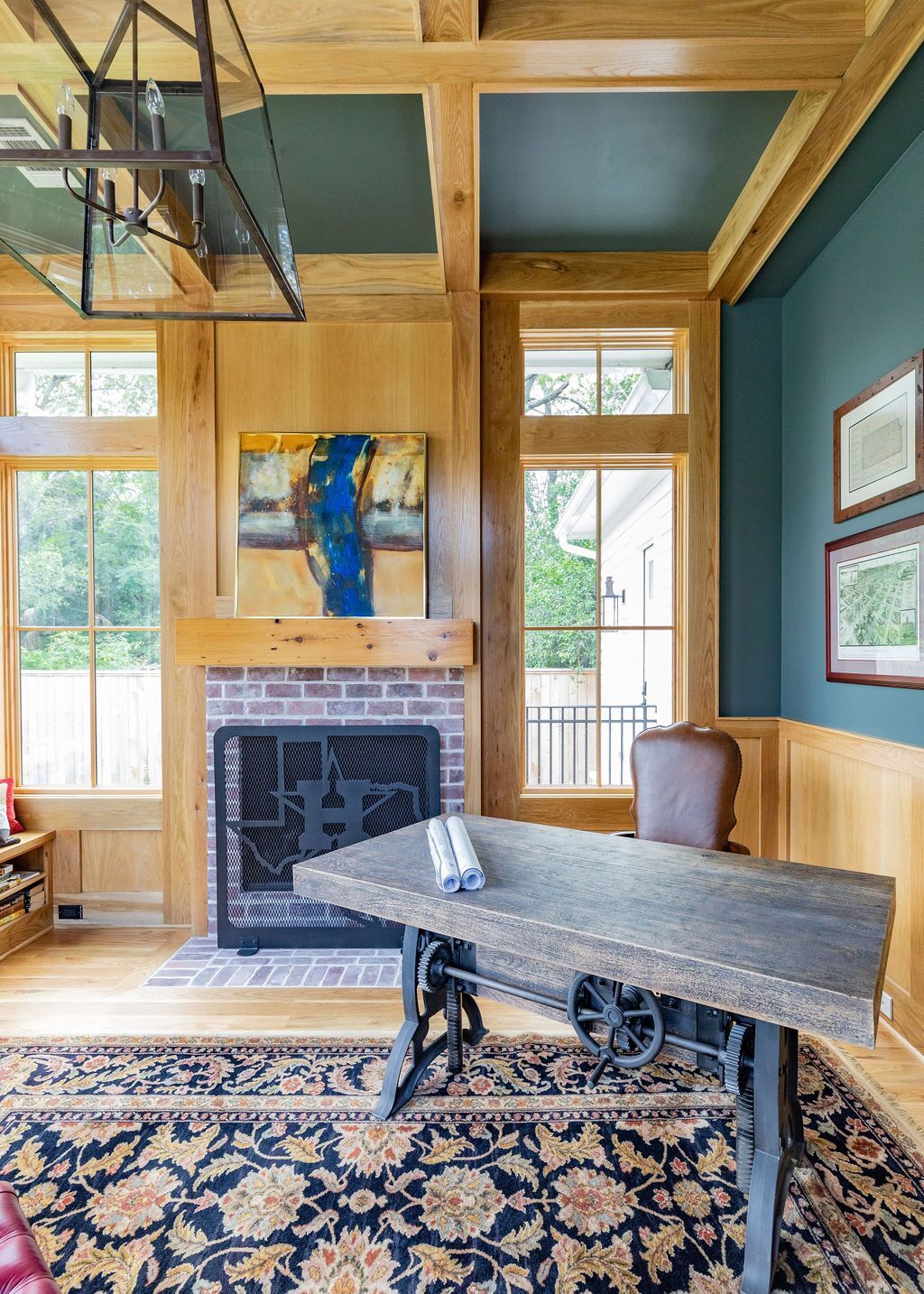 A living room with a fireplace and a desk.