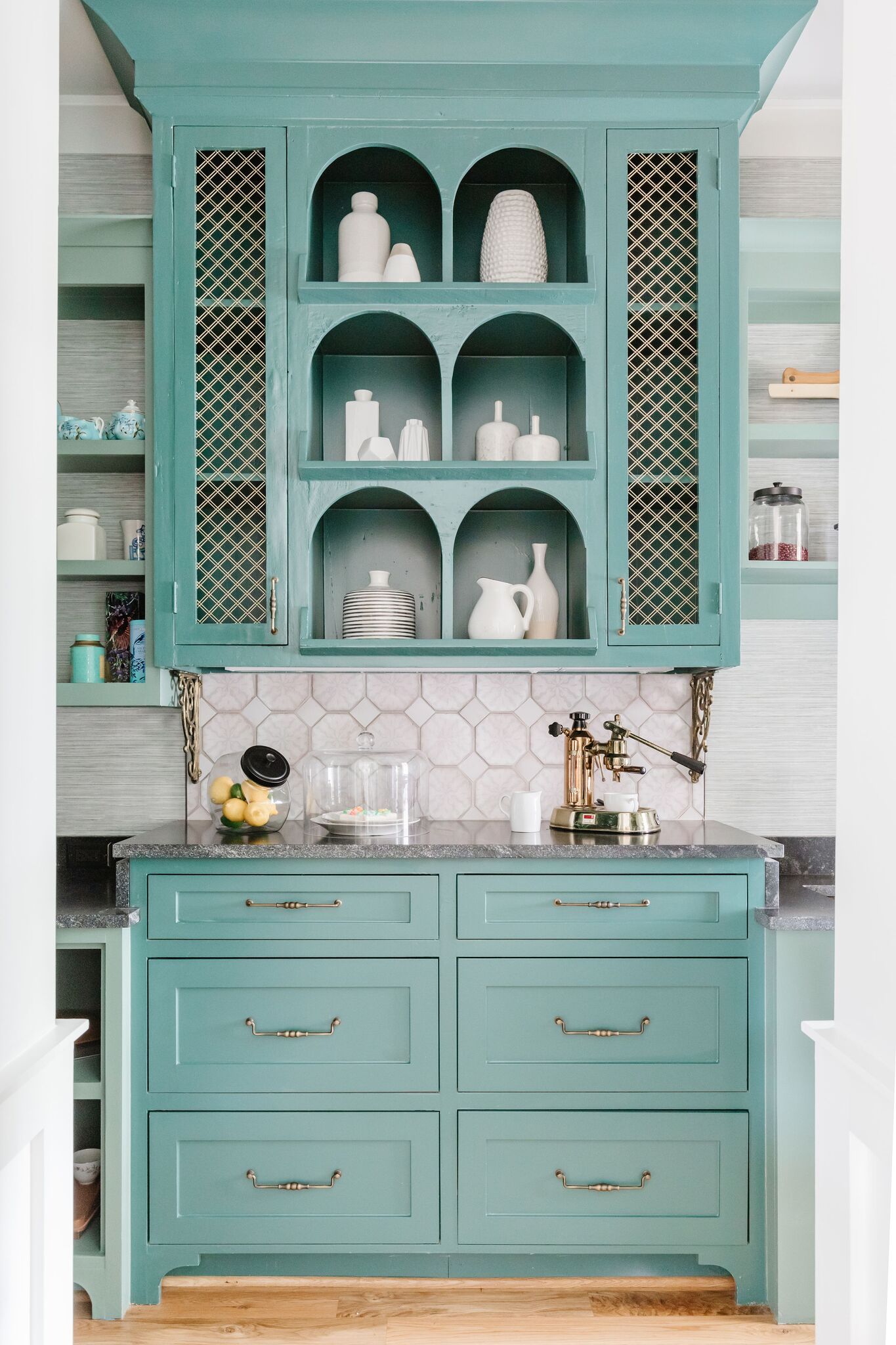 A kitchen with blue cabinets and a wine rack.