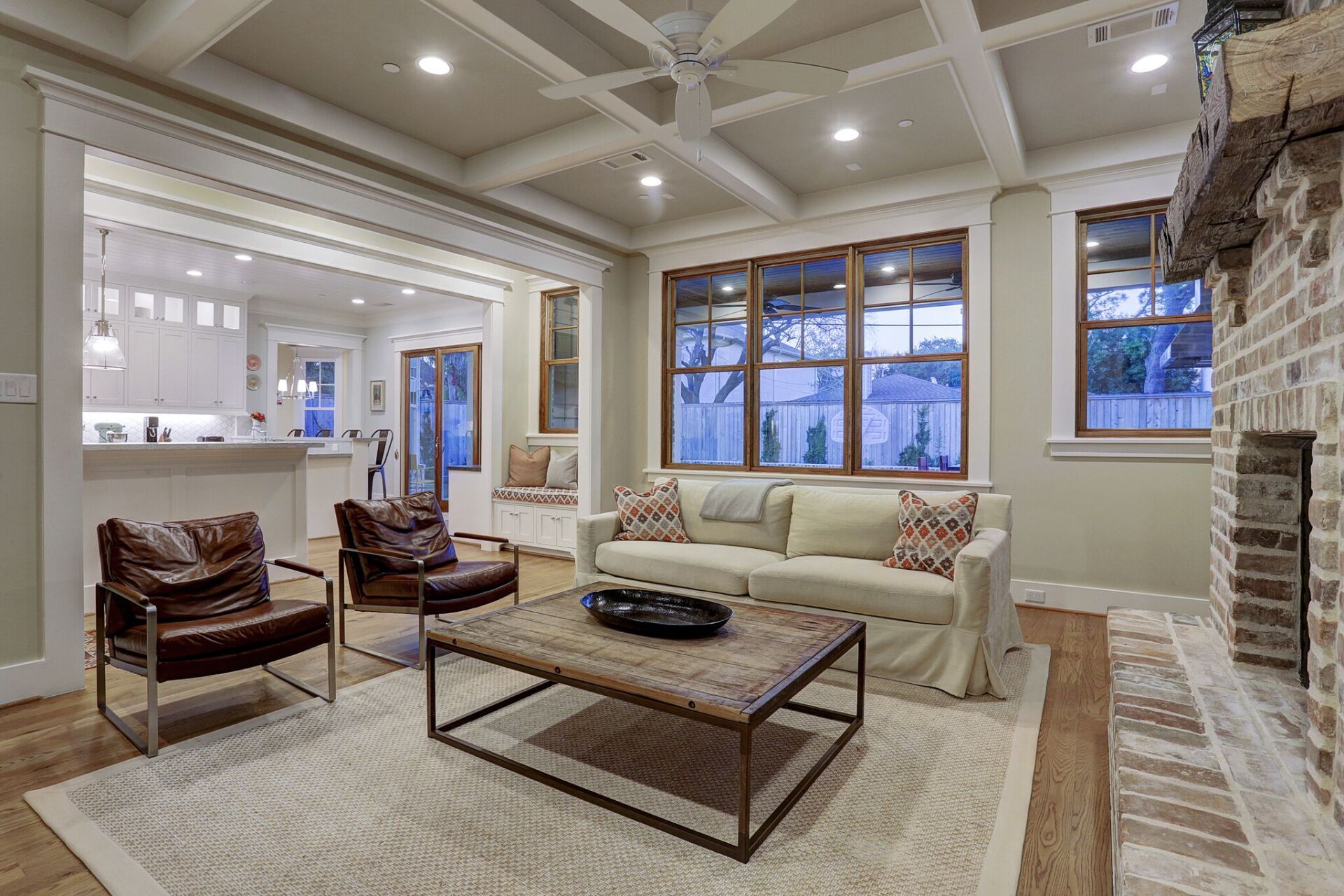A living room with a couch , chairs , coffee table and fireplace.