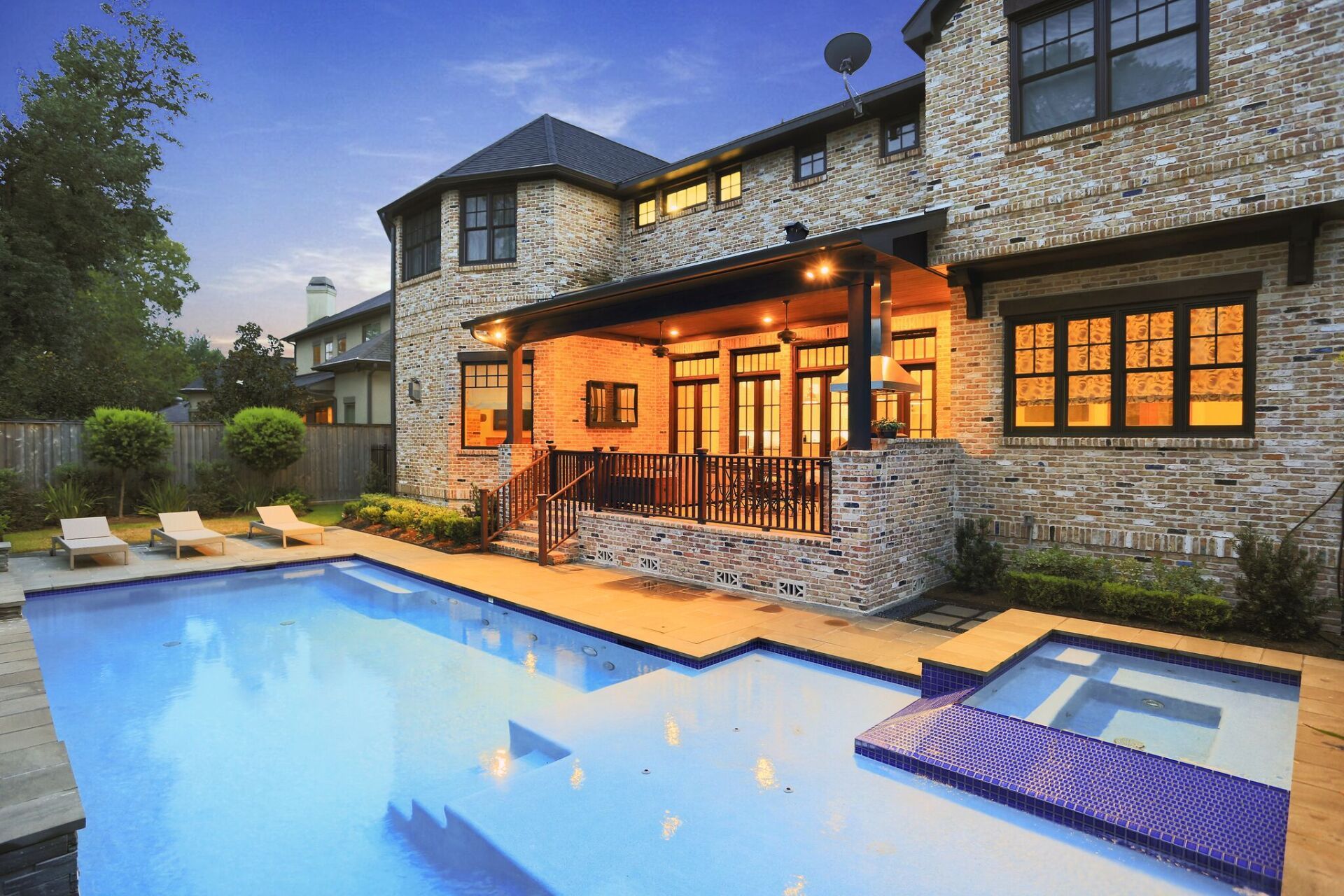A large house with a large swimming pool in front of it