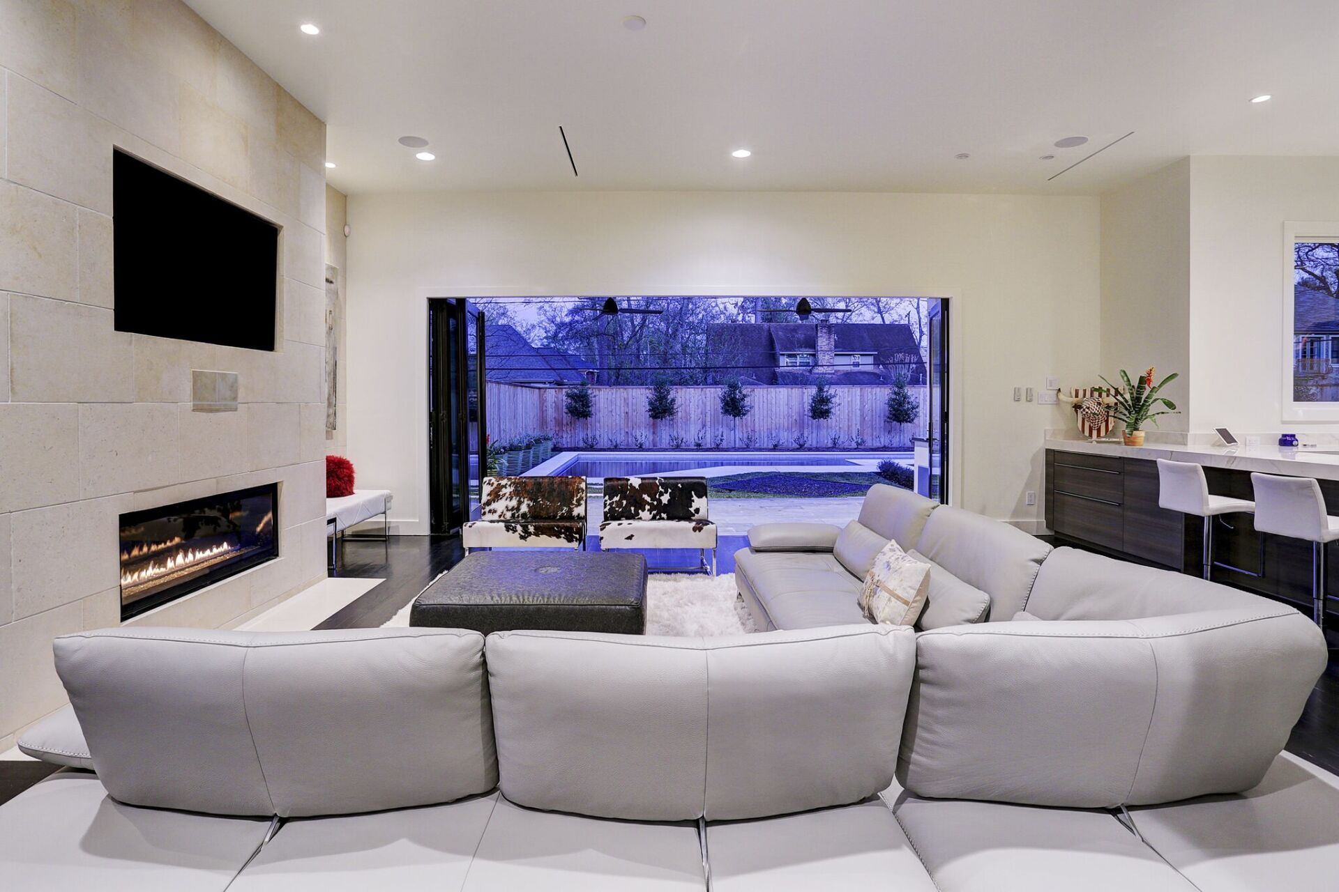 A living room with a large sectional couch and a fireplace.