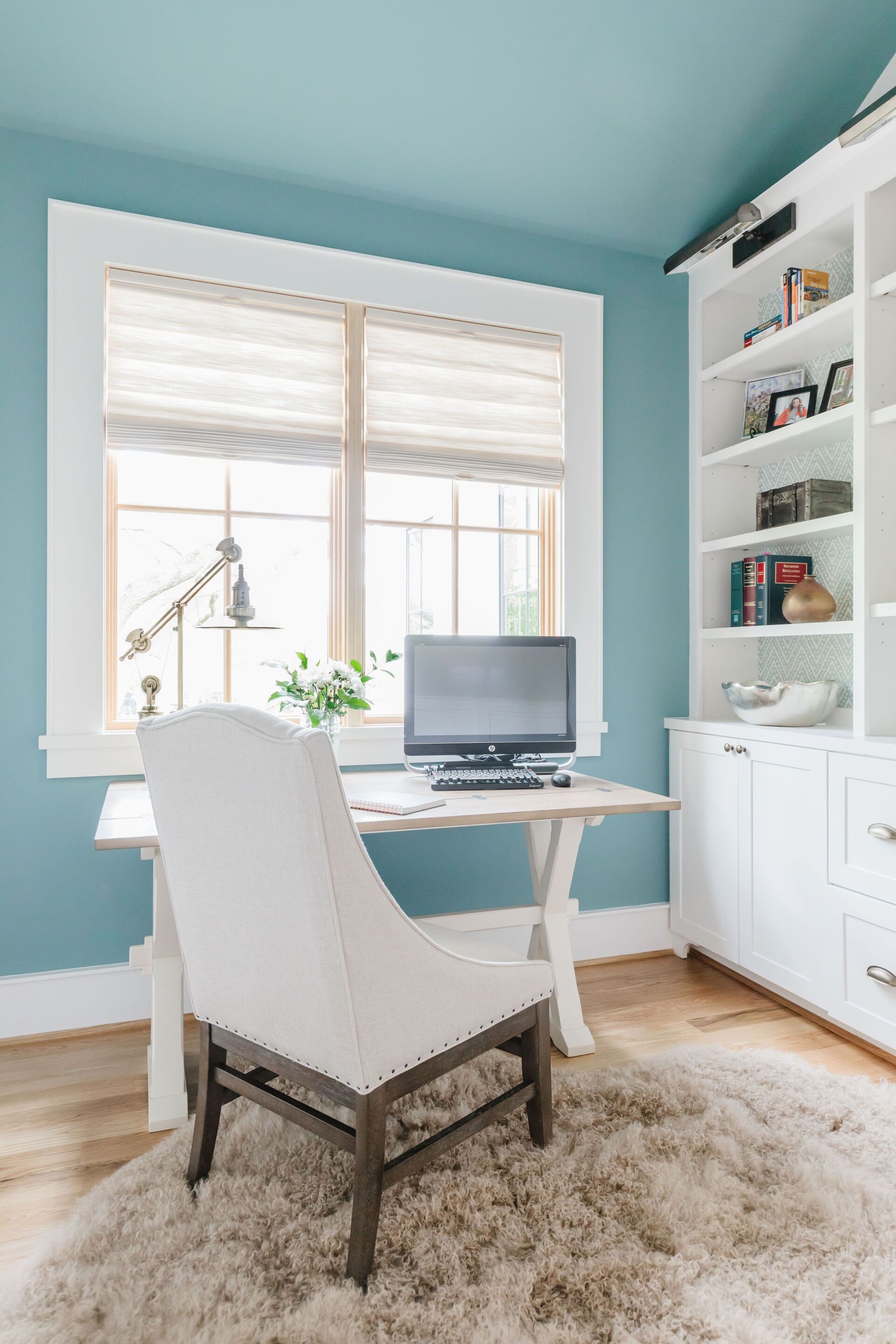 A home office with a desk , chair , and computer.
