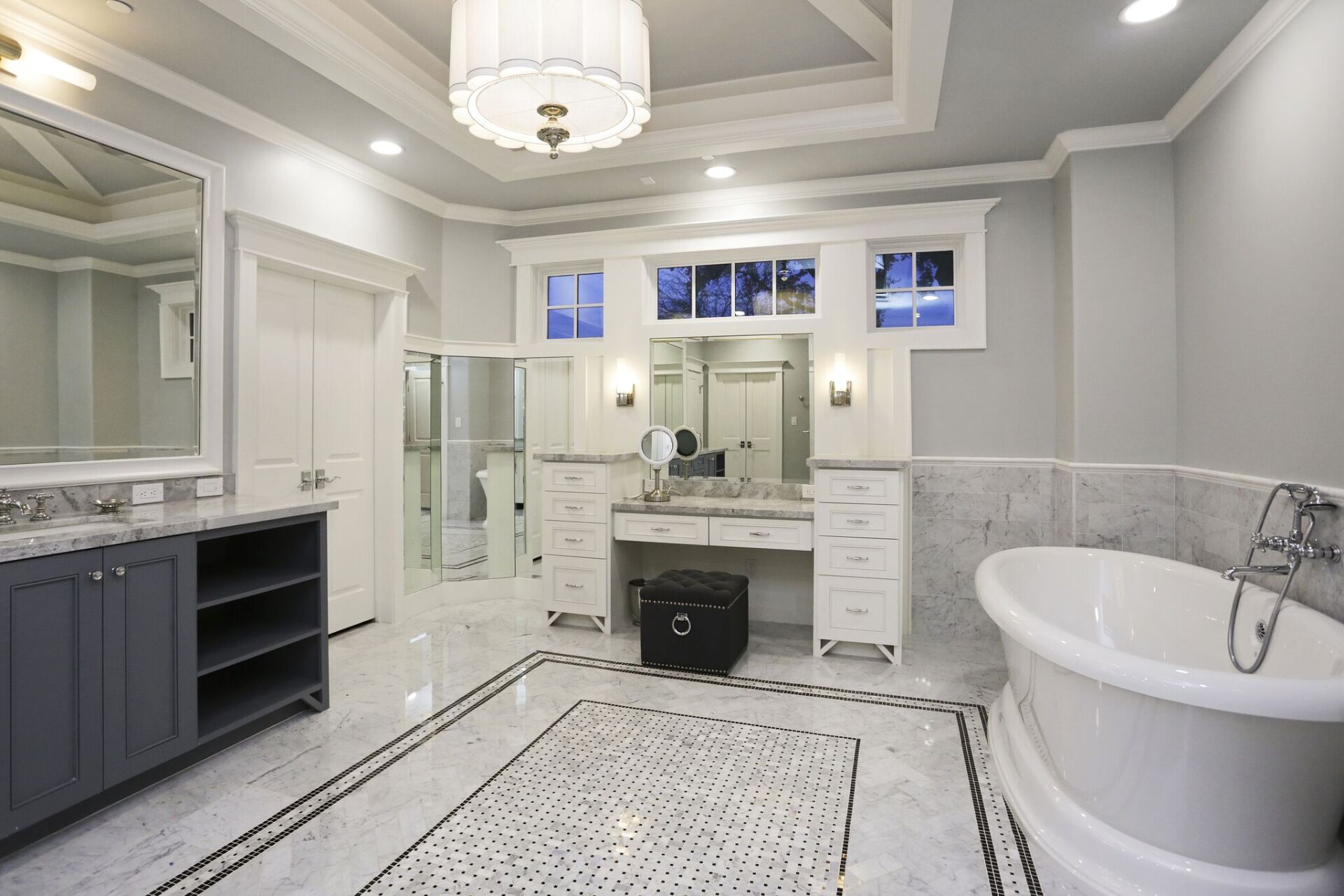 A bathroom with a tub , sinks and mirrors