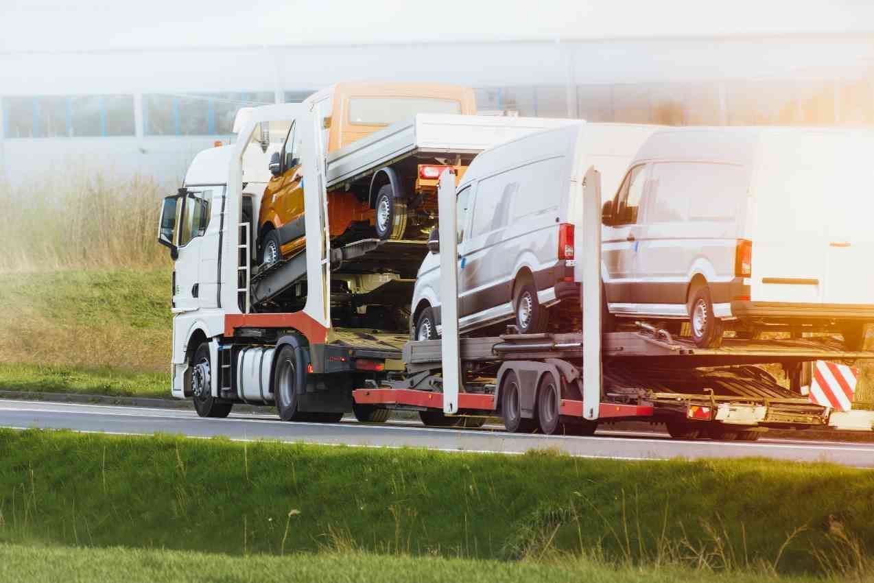 A Truck Is Carrying A Bunch Of Cars On A Trailer — Venus Couriers Pty Ltd In Mackay, QLD
