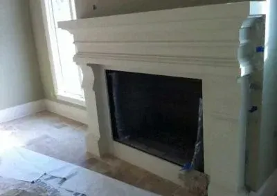 Fireplace with a white mantel, dark interior, and tiled floor.